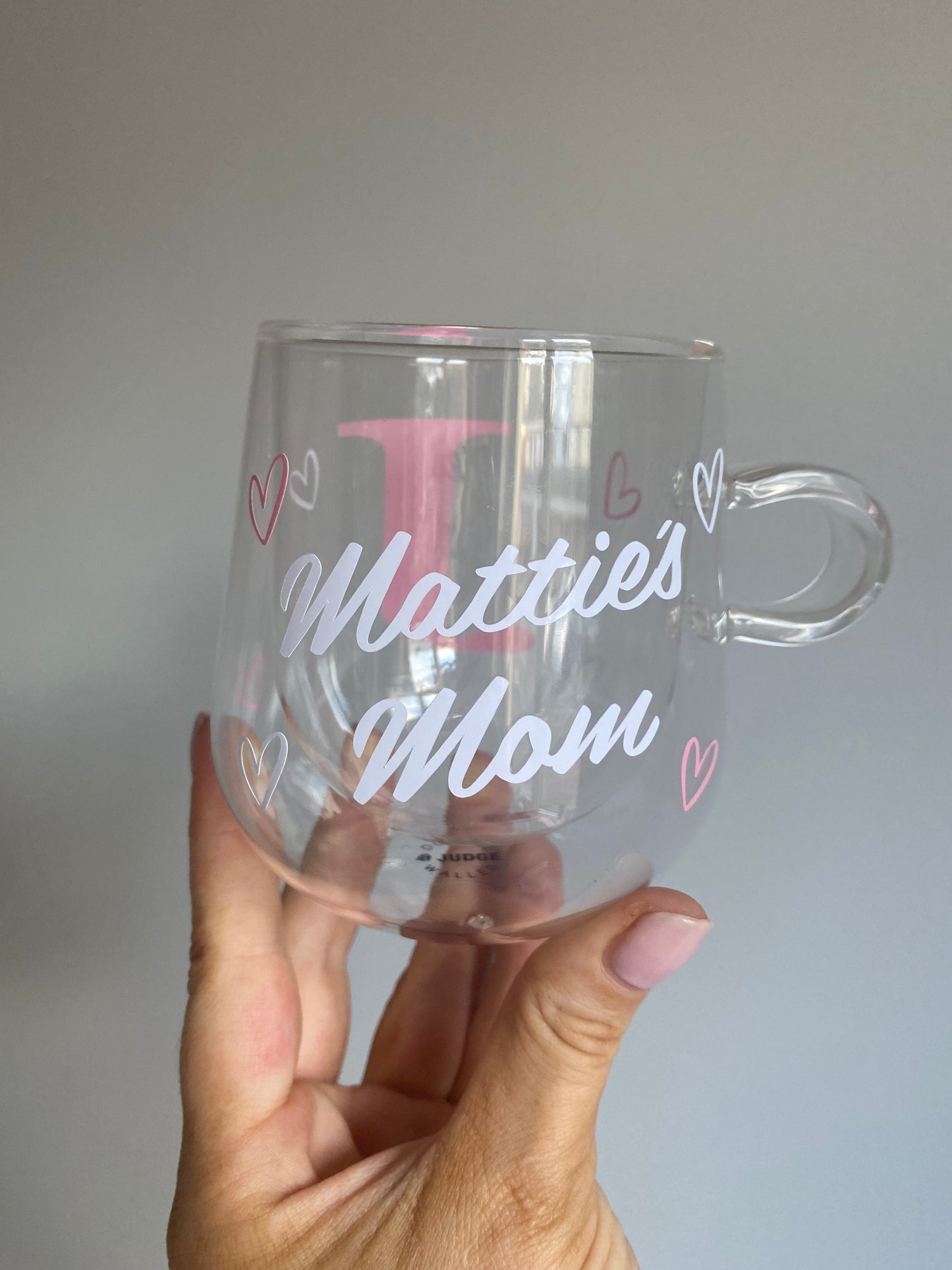 Pink initial, white name